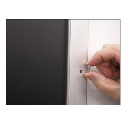 REMOVE SECURITY SCREWS FROM THE FRAME PROFILE TO REPLACE POSTERS 10 x 12