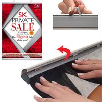By hand, simply snap open both snap bar rails, top and bottom, slide graphic or poster in, and snap close 